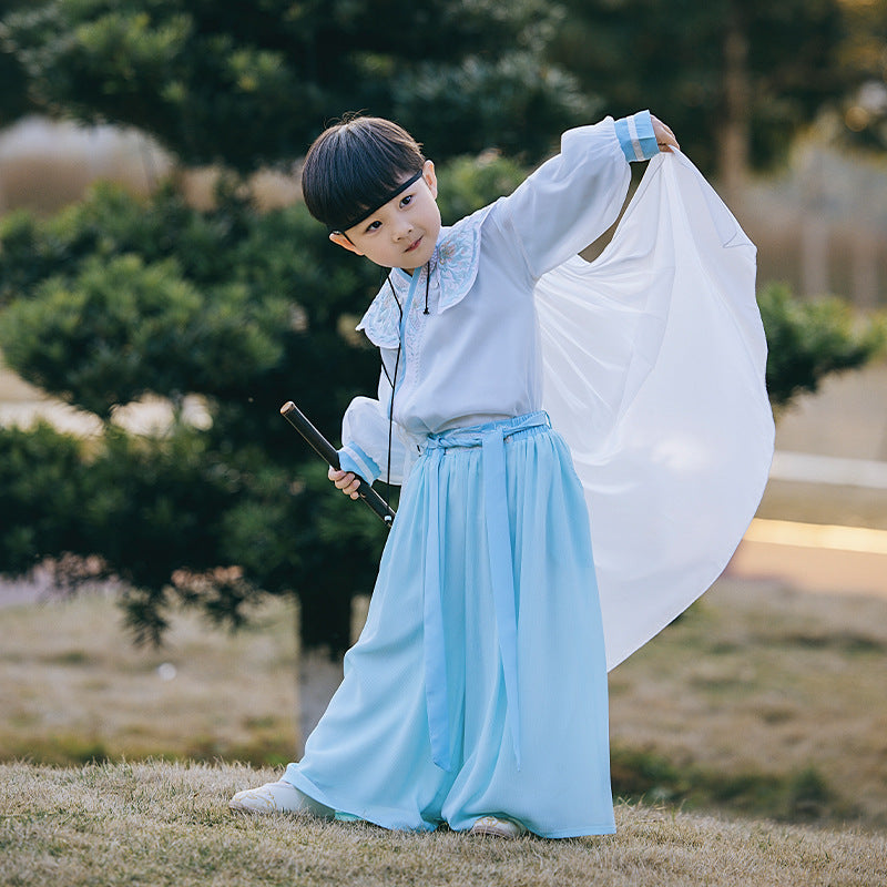 A boy modeling a pair of pants with an elastic waistband in a blue breathable fabric,Great for outdoor cultural festivals
