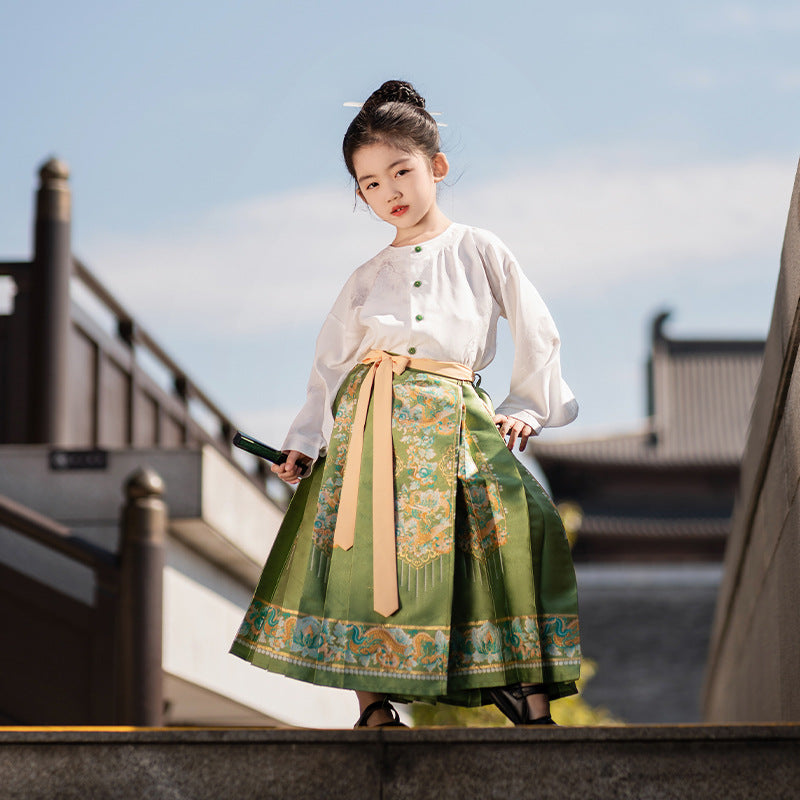 A young girl wearing an emerald green silk hanfu outfit for a nature walk