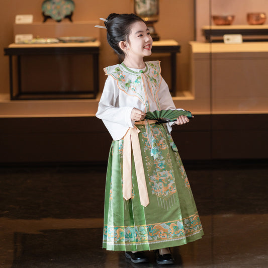 A young girl wearing a green mamianqun hanfu gown for a cultural festival.