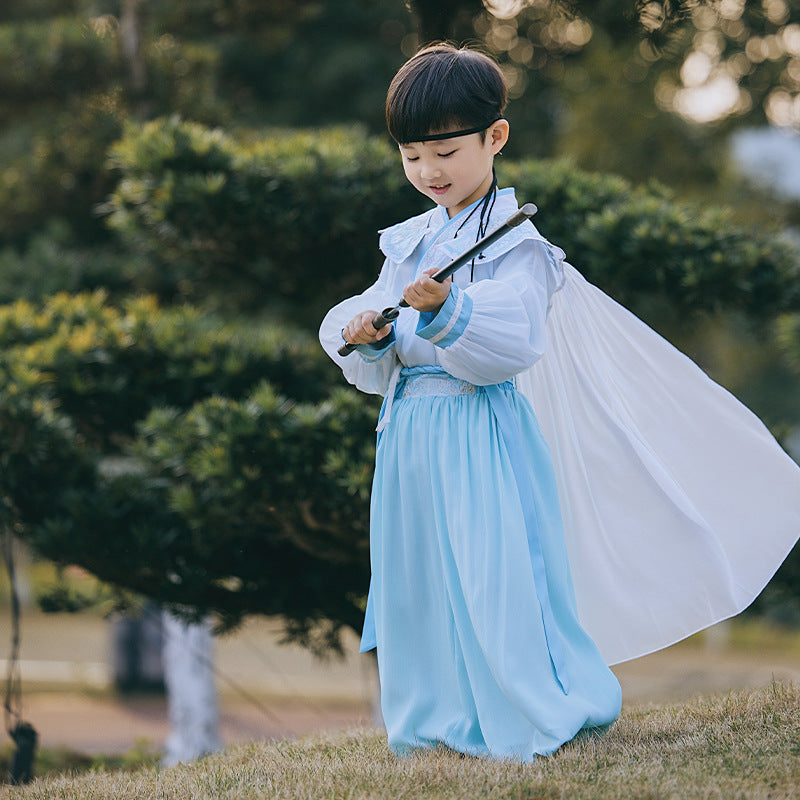 A boy modeling a white Hanfu top with hand-embroidered designs, perfect for a traditional Chinese cultural festival