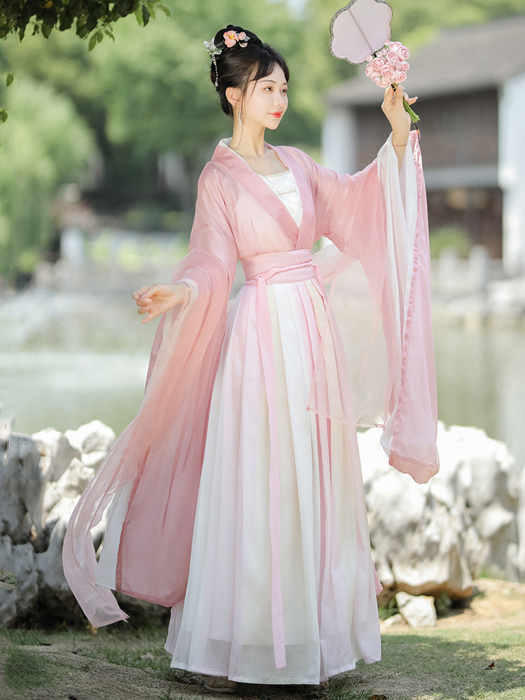 A model wearing a pink hanfu dress for female, The gauze material is very breathable and suitable for going out in spring and autumn to participate in Chinese cultural experience activities